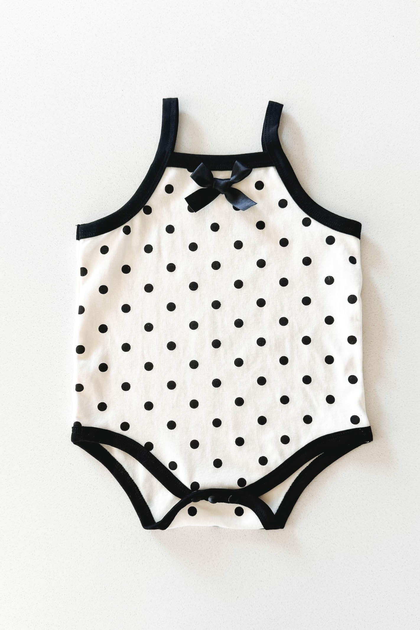 Cream and black polka dot baby bodysuit