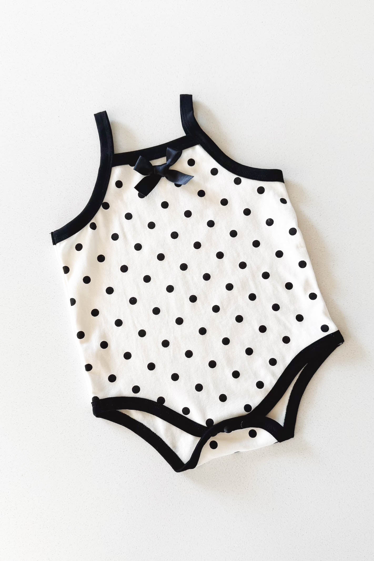 Cream and black polka dot baby bodysuit