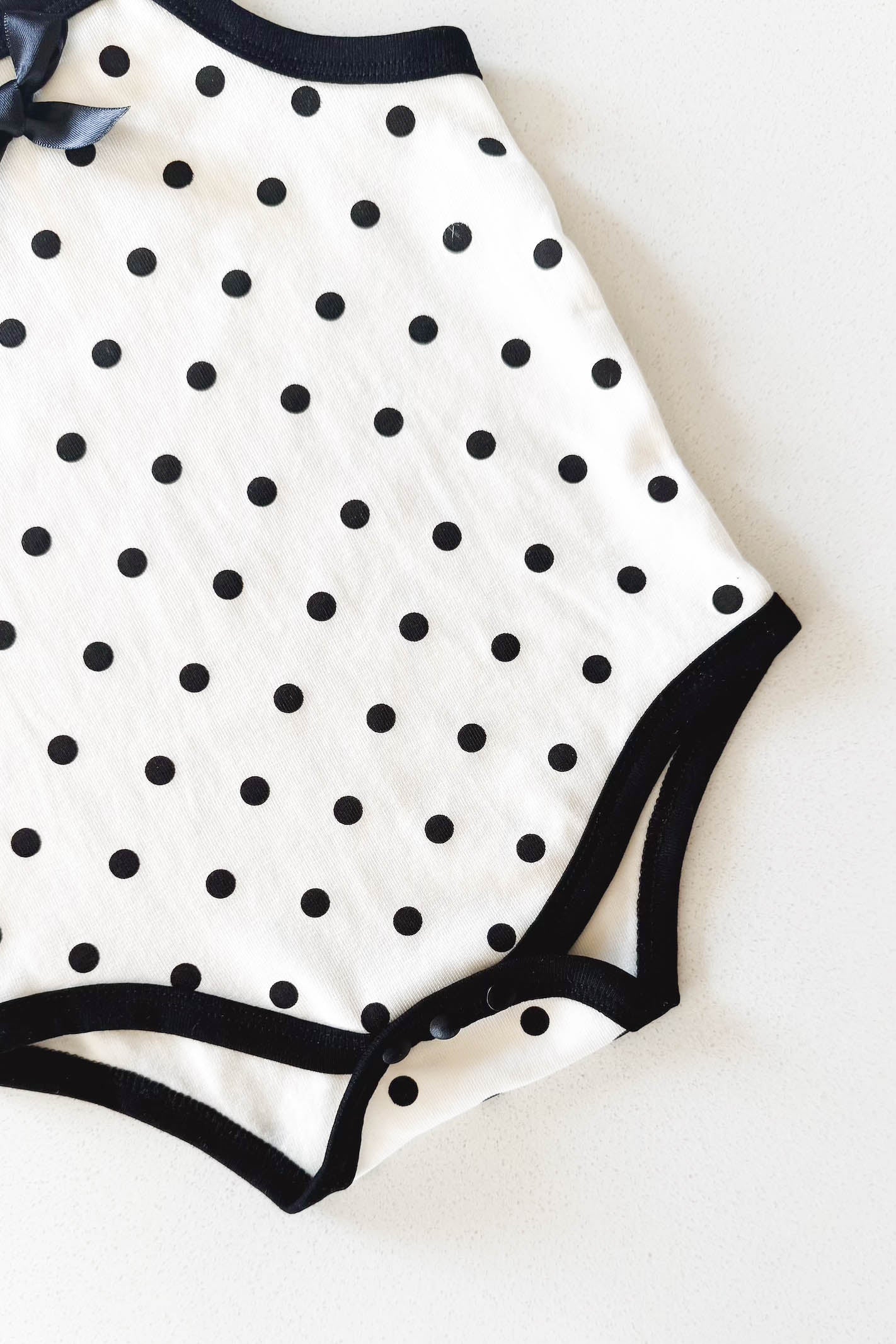 Cream and black polka dot baby bodysuit