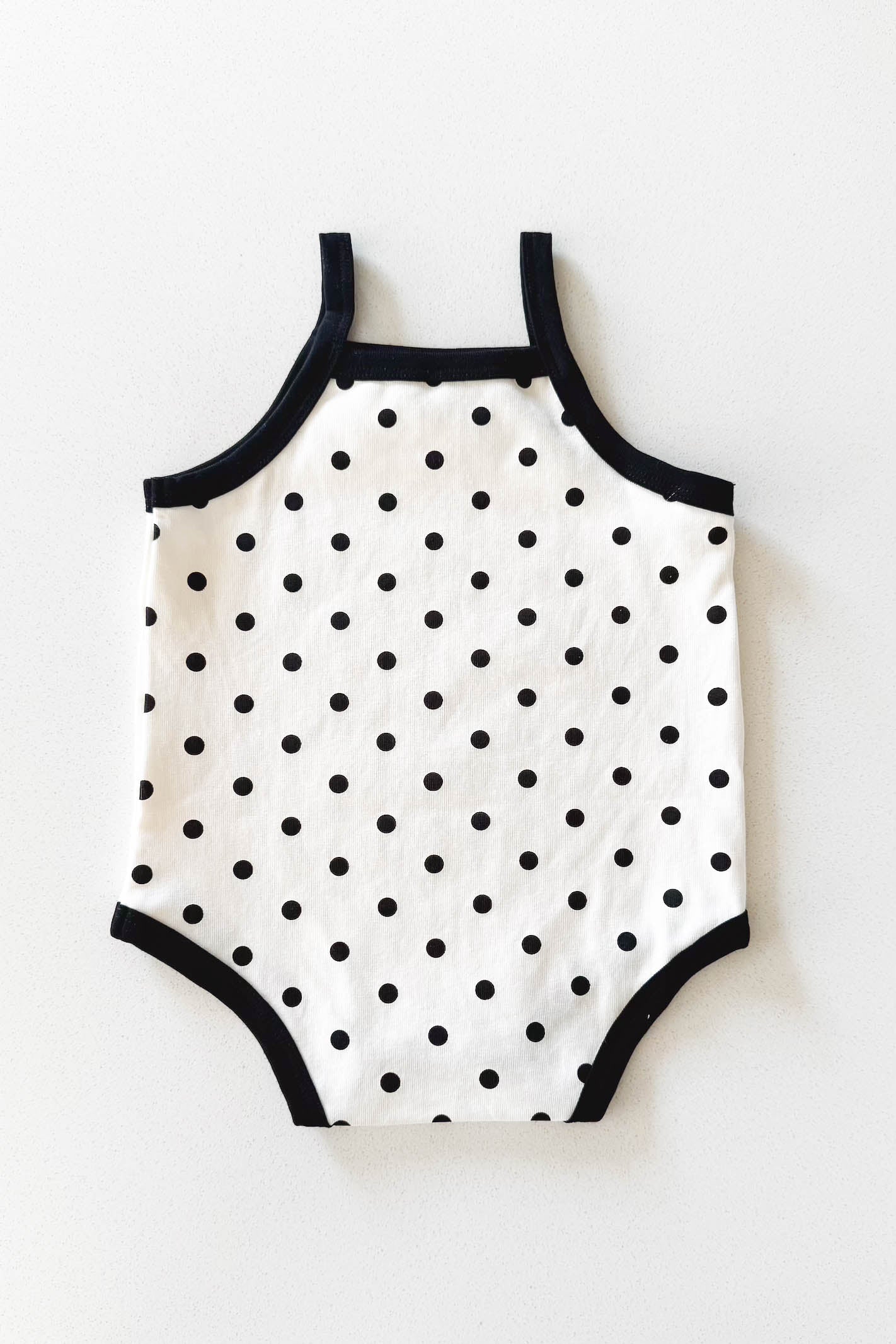 Cream and black polka dot baby bodysuit
