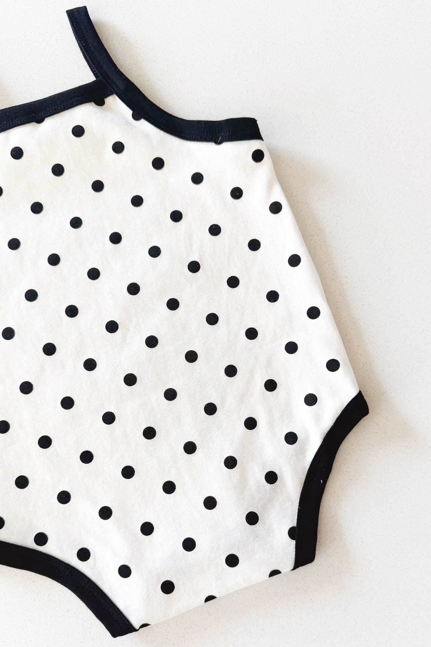 Cream and black polka dot baby bodysuit