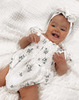 baby wearing floral bodysuit